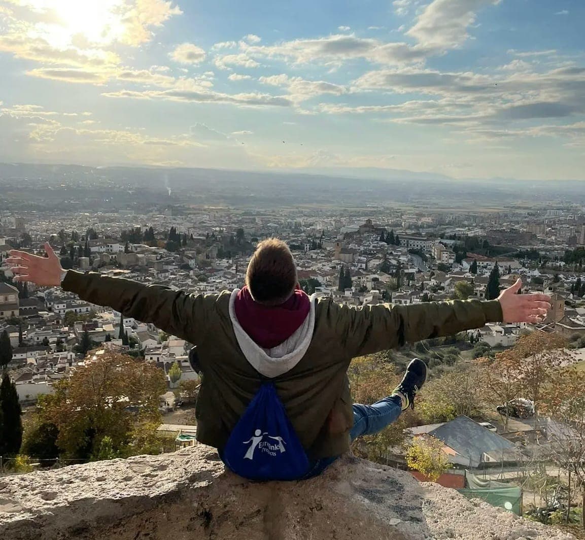 Boy sitting with a view of Granada